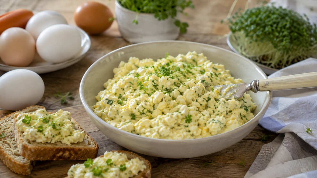 Cremiger Eieraufstrich mit Schnittlauch und Petersilie auf kleinen Broten